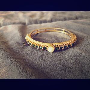 Gold tone bangle with pearl and rhinestone accents